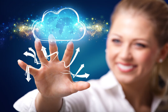 businesswoman interacting with a virtual cloud in front of blue background