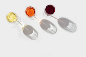 Red, rose and white wine top view in sunlight. Assorted wine, Bar, winery, wine degustation concept.