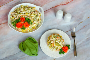 Traditional Russian festive salad Olivier (winter salad) on a white plate