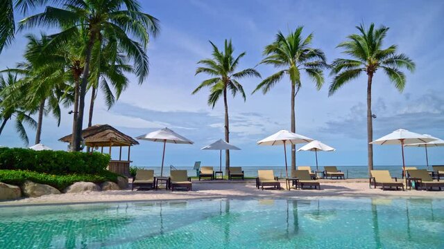 Beautiful umbrella and chair around swimming pool in hotel and resort - vacation concept