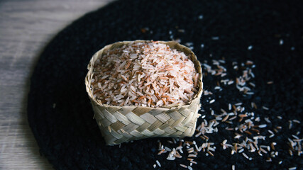 Red rice on wicker basket