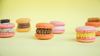 assortment colorful  korean macaroons on yellow background