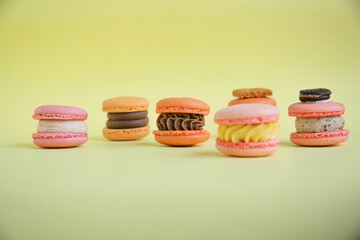 assortment colorful  korean macaroons on yellow background