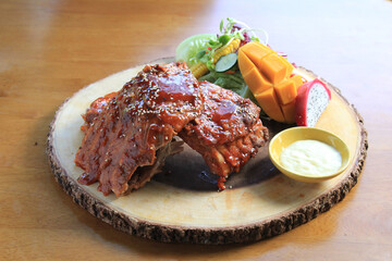 Grilled and smoked ribs with barbeque sauce on a carving board
