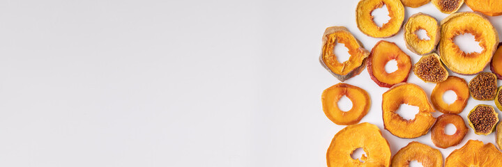 slices of dried persimmon, peach, plum and figs on a white background. dried fruits. eco.