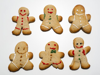 Group of homemade Christmas gingerbread cookies isolated on white background. Male or female cookies. Decorated Christmas cookies