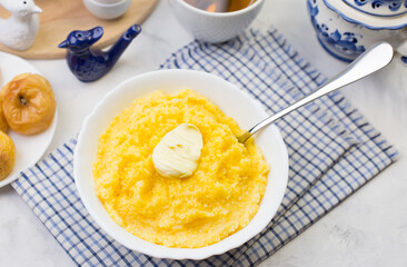 Delicious and healthy Breakfast with corn porridge and baked apples.