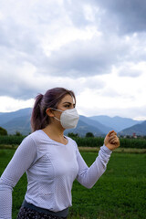 woman with mask running in the field