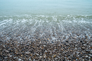 French coastline of Normandy in France with pebbles beaches, part of the typical landscape 