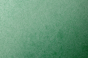 Abstract background with green texture, velvet fabric, close-up. Colorful felt texture for background with copy space. Felt fabric sheet