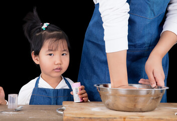 The chef is making noodles and the kids are playing