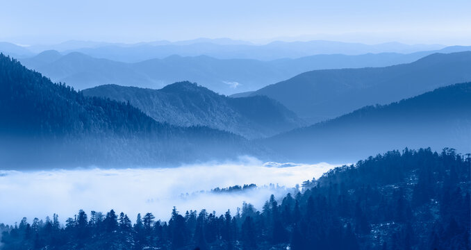 Beautiful landscape with cascade blue mountains at the morning - View of wilderness mountains during foggy weather © muratart