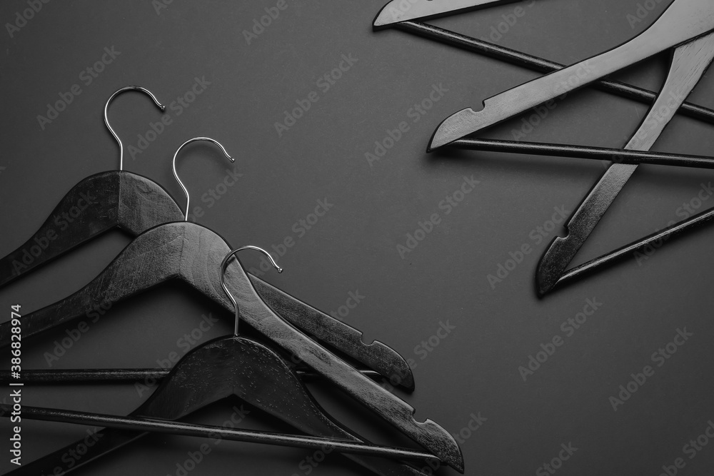 Wall mural Clothes hangers on dark background