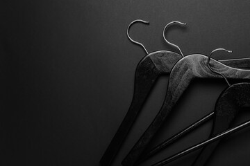 Clothes hangers on dark background