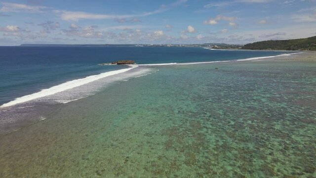 Drone shot rising up over the waters of the tropical island Guam`