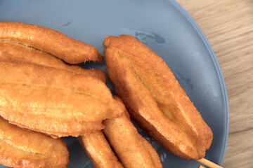 A plate of fried golden fried dough sticks