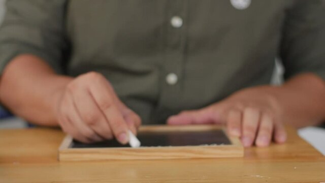 New Mindset new result. Male writing on chalkboard. Motivational inspirational self development quote text concept