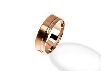 Golden wedding ring on a white background.