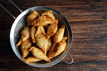 Banana snack from Indonesia called `Molen` or `Pisang Molen`. Bananas are wrapped in flour dough and then fried before serving. Molen are served with powdered sugar for sweetening.