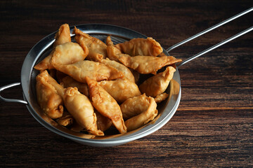 Banana snack from Indonesia called `Molen` or `Pisang Molen`. Bananas are wrapped in flour dough and then fried before serving. Molen are served with powdered sugar for sweetening.