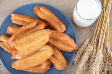 Breakfast fritters, milk and a handful of wheat ears