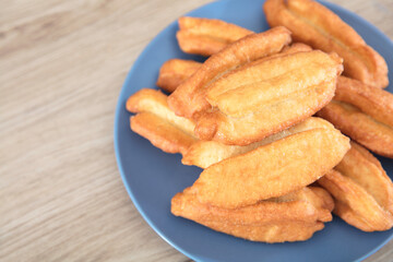 Looking down and shooting a plate of fried dough sticks