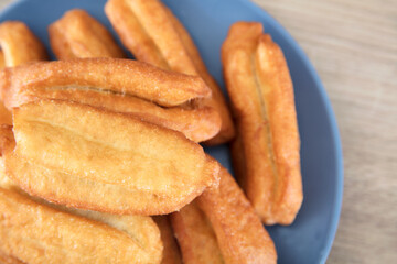 Looking down and shooting a plate of fried dough sticks