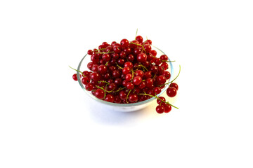 Isolated on white background red currant berries in a transparent plate