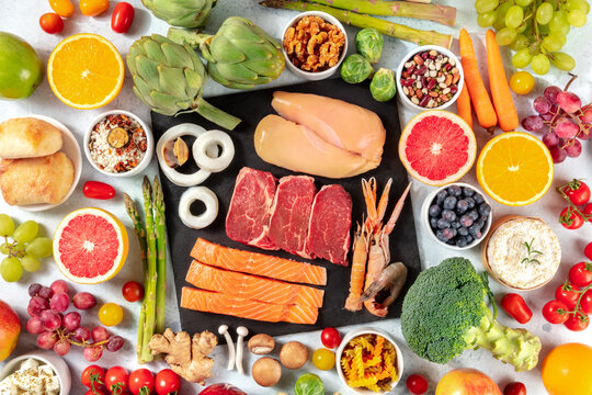 Various Food Products, Shot From The Top. Meat And Fish, Poultry, Seafood, Cheese, Fruit, Vegetables, Nuts, Legumes, Mushrooms. A Flat Lay The Concept Of A Balanced Diet