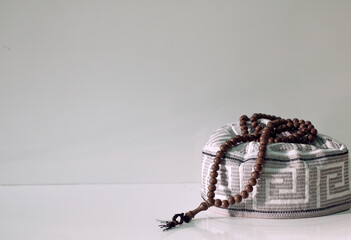 rosary prayer beads on top of cap to pray