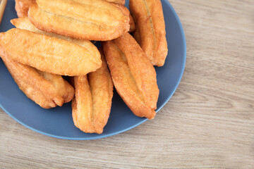 A plate of golden fried dough sticks