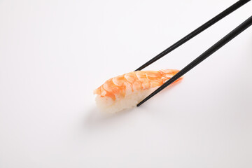 Shrimp sushi with chopsticks Japanese food isolated in white background