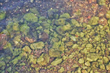 Color stones and flowing water in light