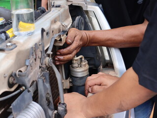 Mechanic working on the engine in an auto repair shop