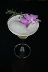 Pink Cocktail glass with ice at a bar counter