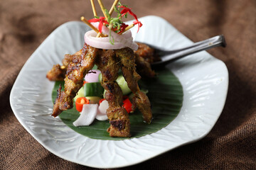 Chicken Satay on dark brown table street food appetizer