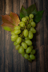 Fresh green grapes on a wooden table