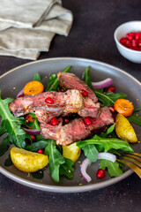 Grilled beef steak salad with arugula, potatoes, carrots, onions and pomegranate. Healthy eating. Diet.