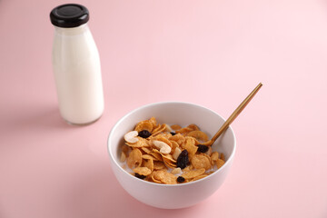 Cereal dessert with corn oat and dry fruits isolated in pink background