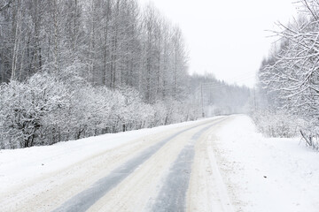 First snow, road after snowfall. Snowy road in the forest