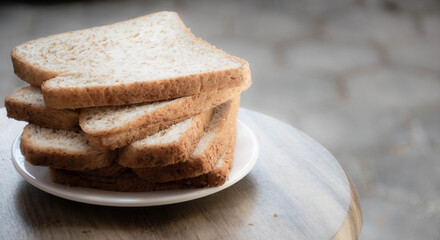 sliced whole grain, whole wheat  bread on the white plate under the morning light