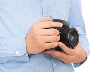 Close-up of photographer holding SLR camera in hand