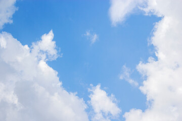 Blue sky background and white clouds soft focus, and copy space