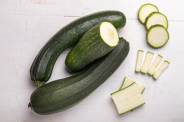 green sliced zucchini on a white wooden table