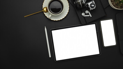 Black table with tablet, smartphone, coffee cup and camera, include clipping path
