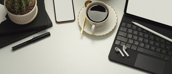 Workspace with tablet, smartphone, coffee cup, accessories and copy space, clipping path