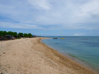 white beach stretching across the clear sky