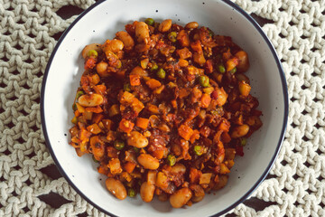 plant-based food, vegan stew with garden vegetables butter beans and spicy tomato sauce