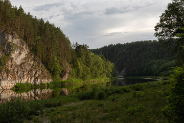 Fototapeta na wymiar Mountain landscape, river flows between mountains in evening sun