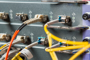 detail of server rack with fiber optic cables attached to front
